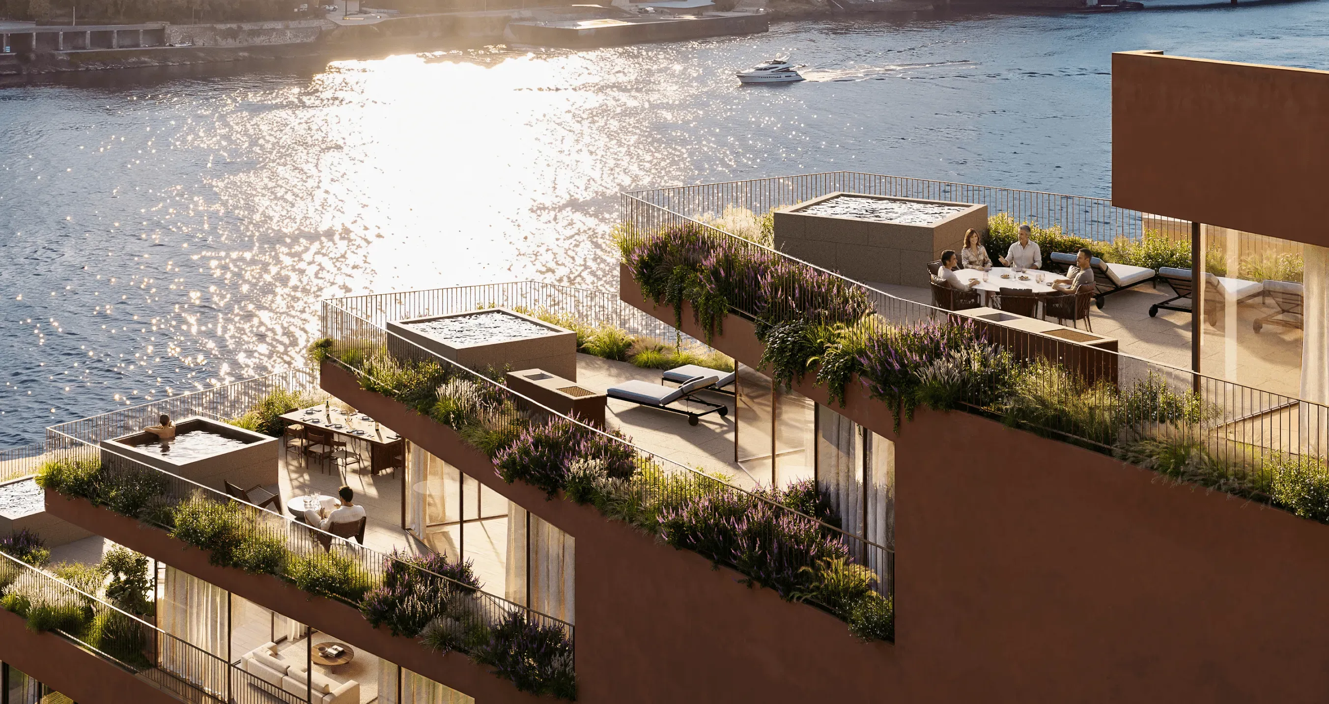 Contemporary waterfront residential development featuring expansive private terraces, lush landscaped gardens, outdoor dining areas, and luxurious hot tubs. Residents relax and socialize while enjoying panoramic river views, with golden sunlight reflecting on the water and creating an elegant, peaceful atmosphere.
