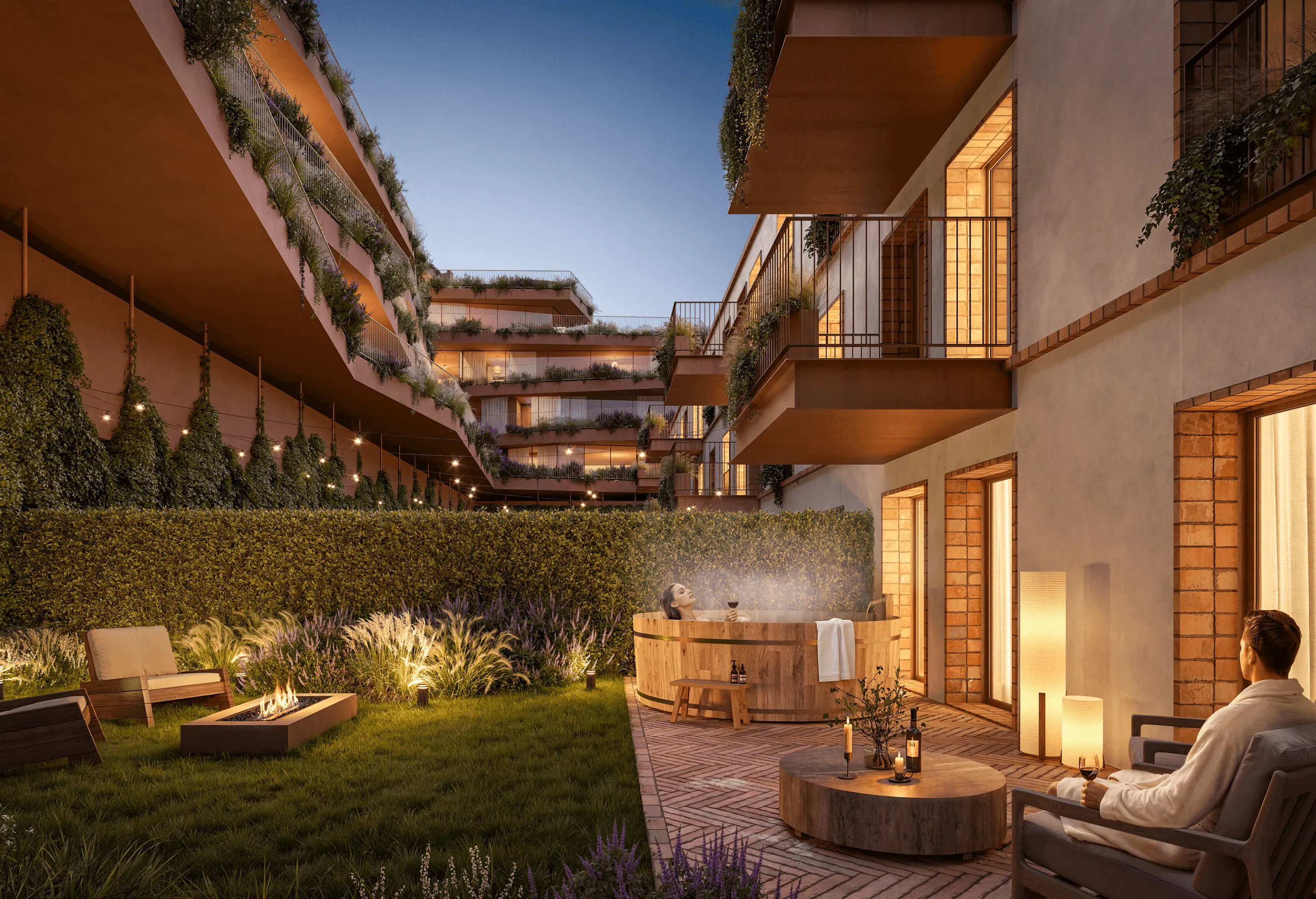 Contemporary residential development featuring private landscaped terraces, lush greenery, spacious balconies, and warm architectural lighting. An inviting outdoor living area with a wooden hot tub, comfortable lounge seating, and a fire pit creates a peaceful atmosphere, where residents relax and enjoy the evening in an elegant, nature-inspired setting.